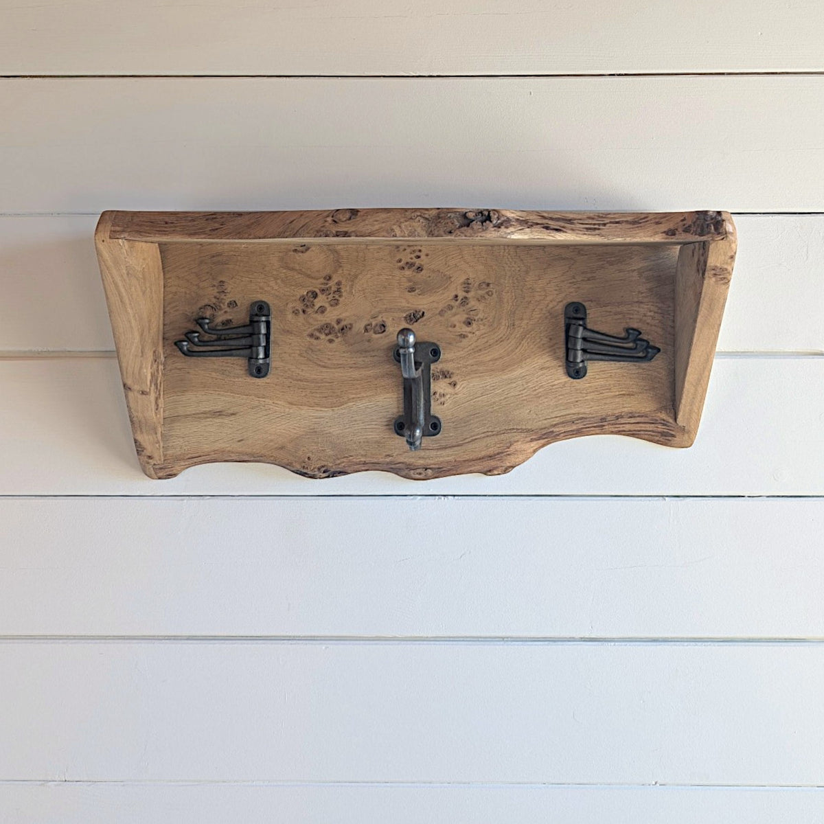 Thriverton live edge pippy oak coat rack with integrated shelf and three rustic cast iron hooks on white wall